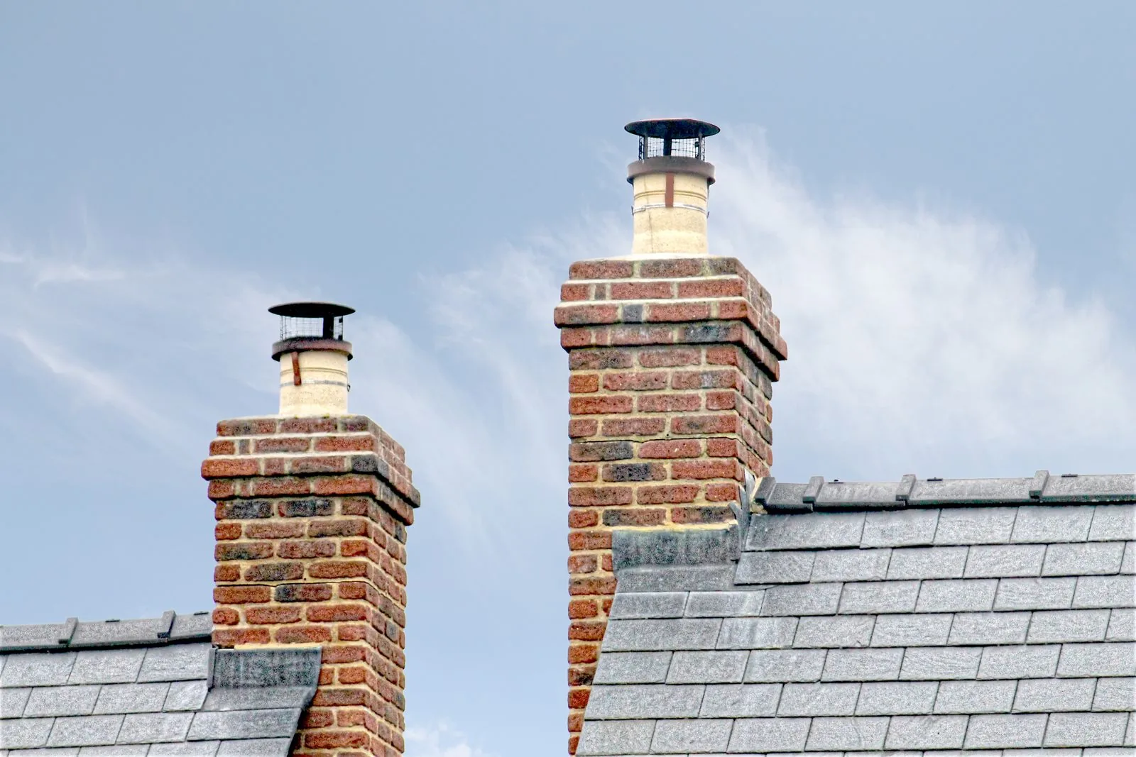 Traditional brick chimneys on a slate roof in England